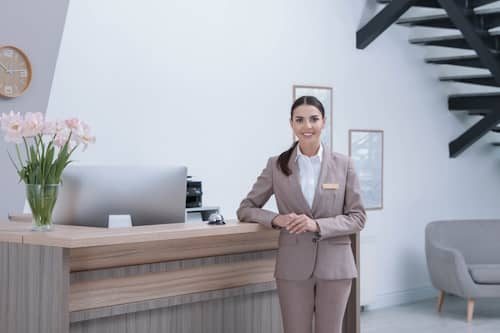 portrait-receptionist-near-desk-modern-hotel-500